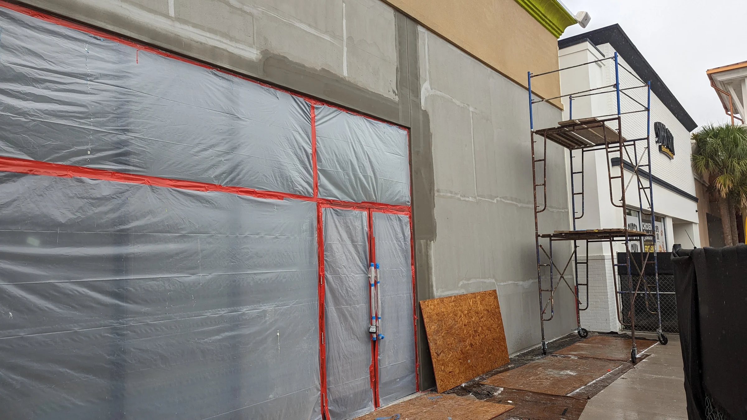 Exterior walls masked and covered during work