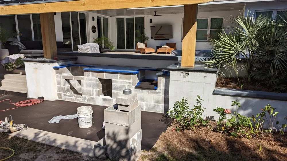 Covered outdoor counter area beside a house