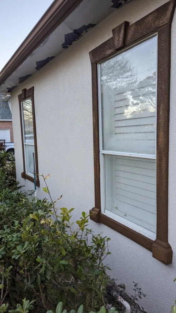 Window set in a white wall with dark trim